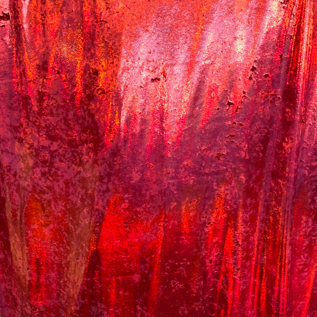 Velvet fabric with red, iridescent, shiny mirror designs, stretches to all 4 sides sold by the yard