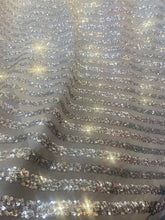 Load image into Gallery viewer, Striped sequin fabric with Mesh silver stretches for all 4 sides in silver sold by the yard
